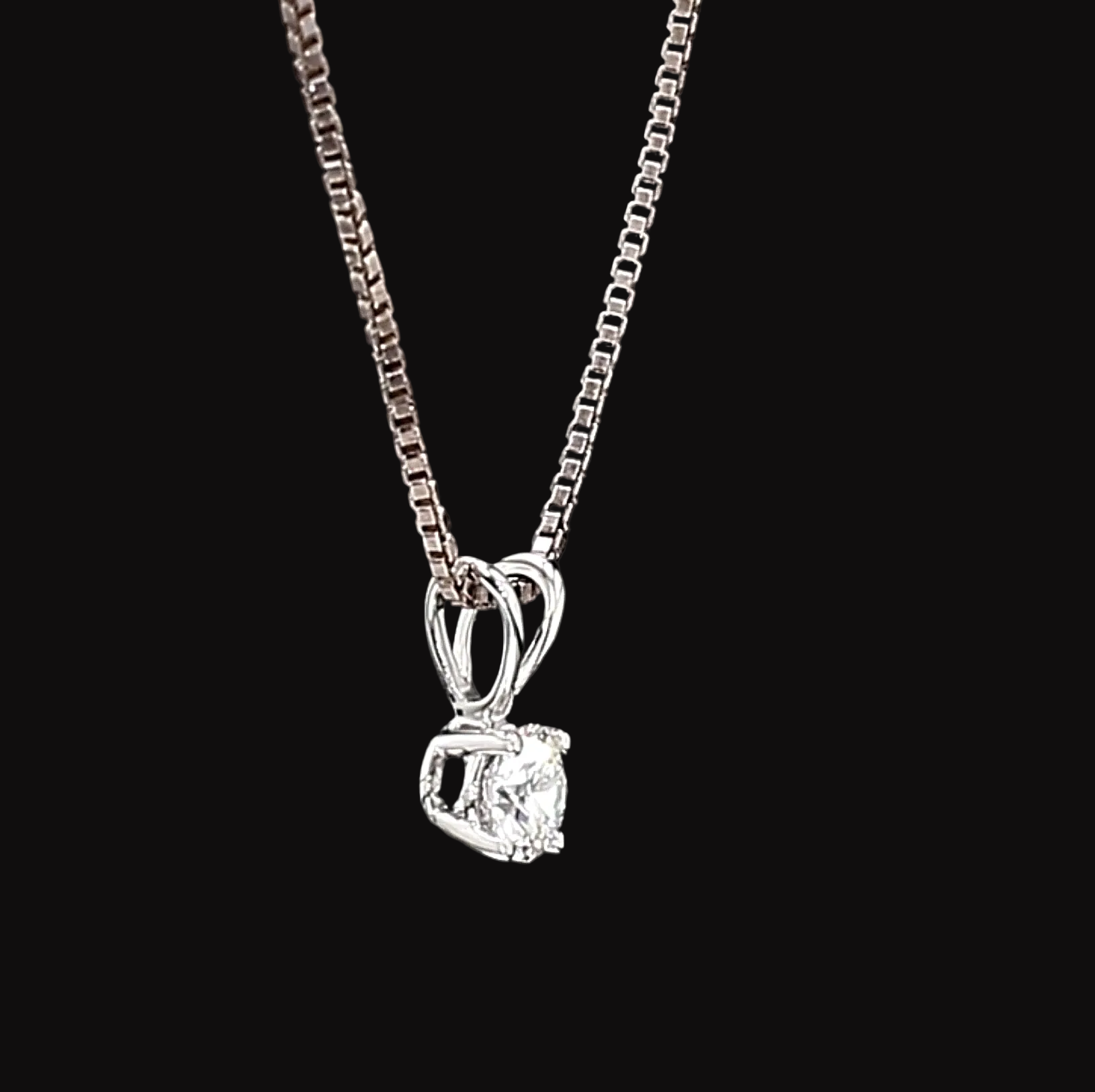 White Gold necklace with a diamond pendant on a black background