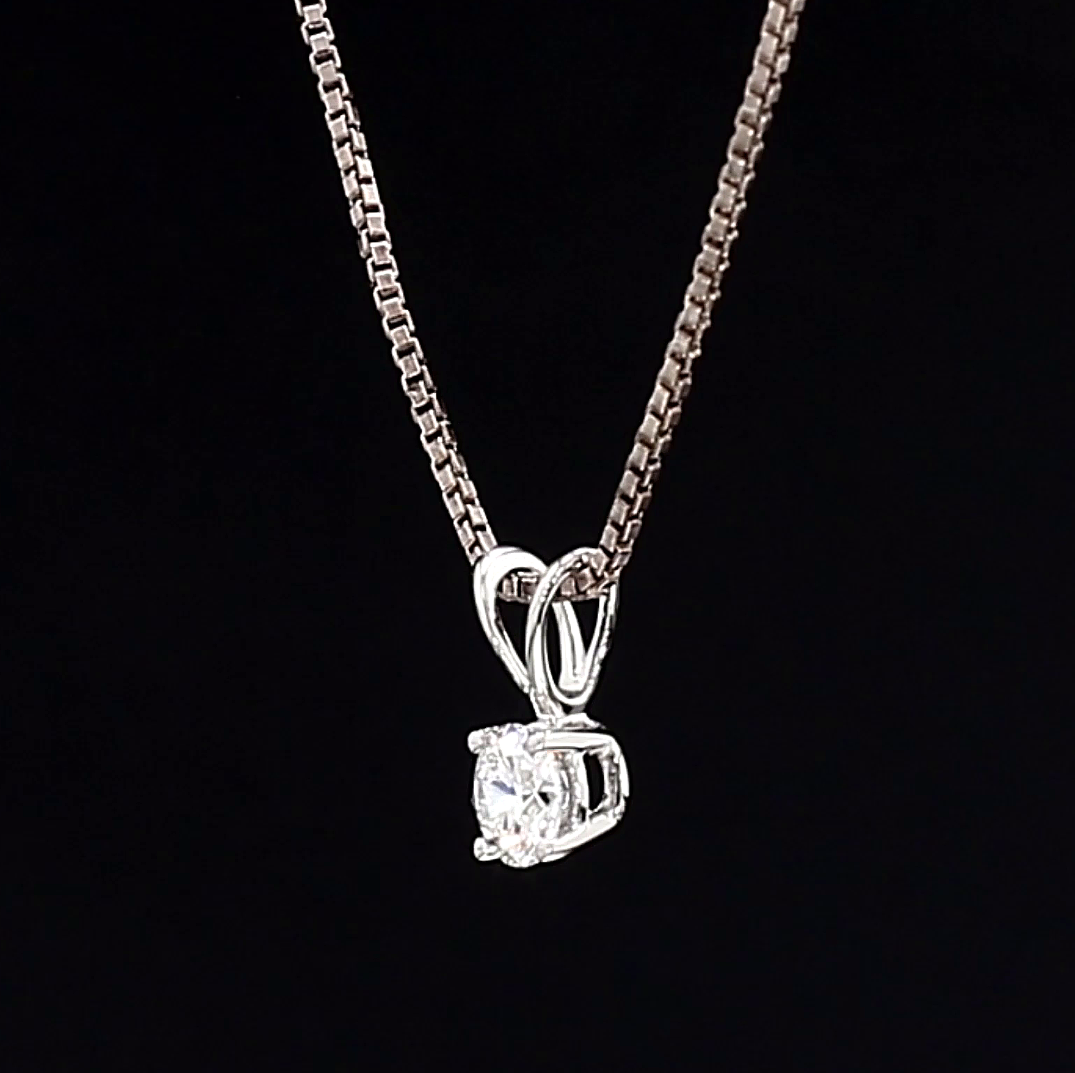 White Gold necklace with a diamond pendant on a black background