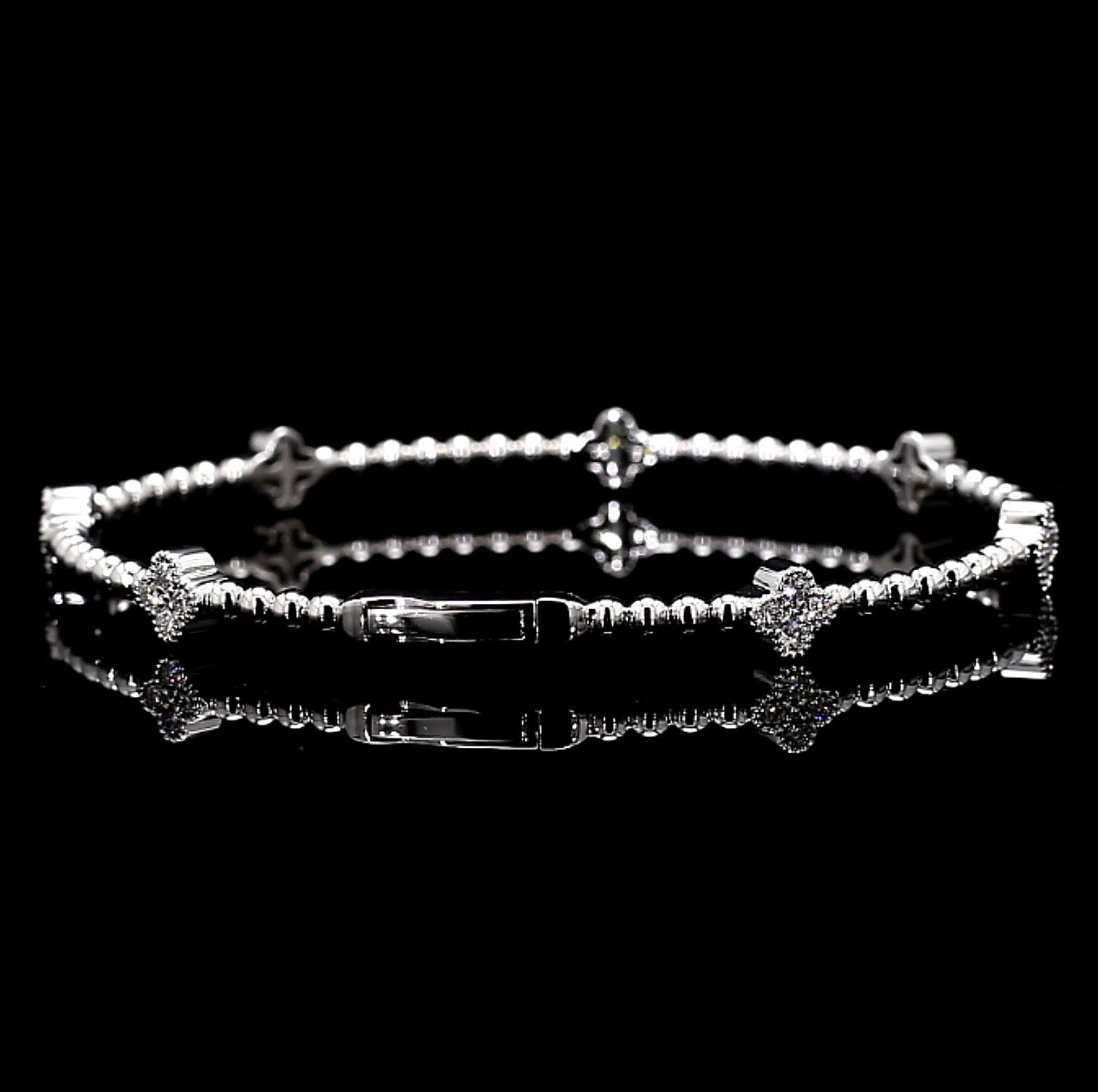 White Gold bracelet with clover charm star and bar designs on a black background