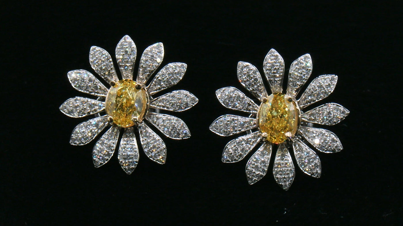Pair of daisy-shaped diamond earrings with a yellow diamond center stone 