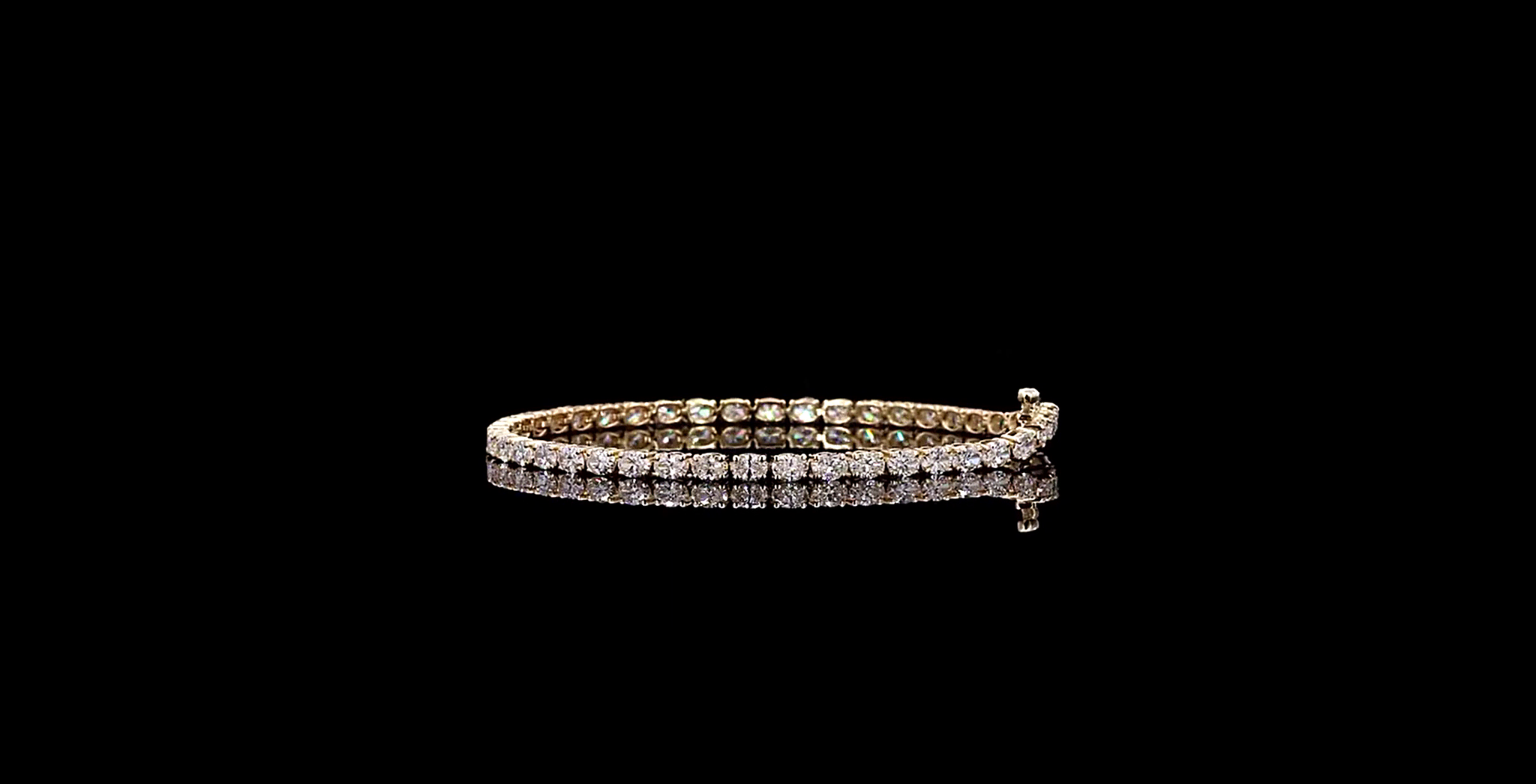 Gold bracelet with diamonds on a black background