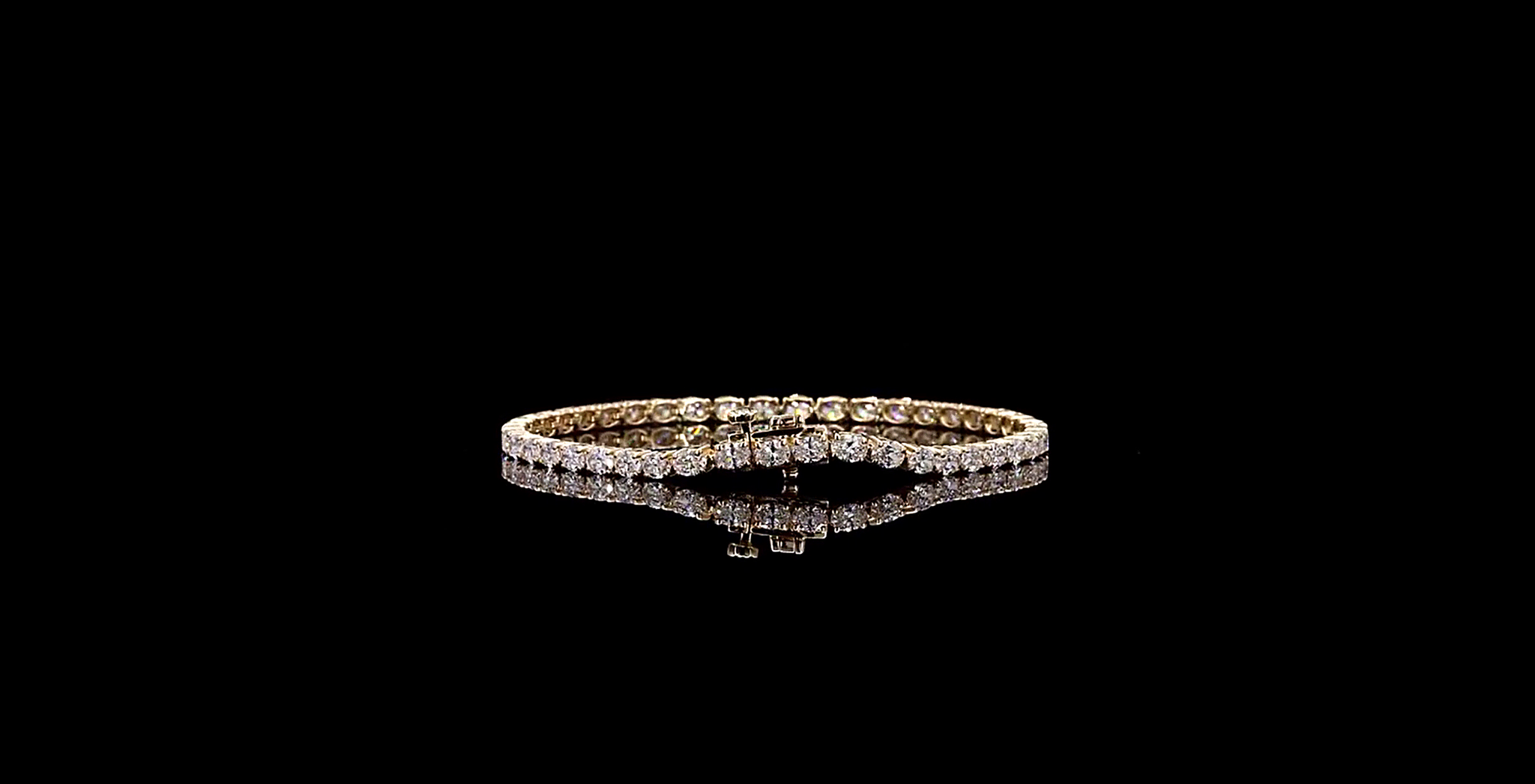 Gold bracelet with diamonds on a black background