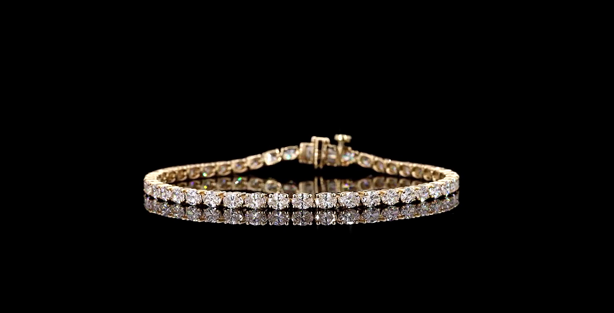 Gold bracelet with diamonds on a black background