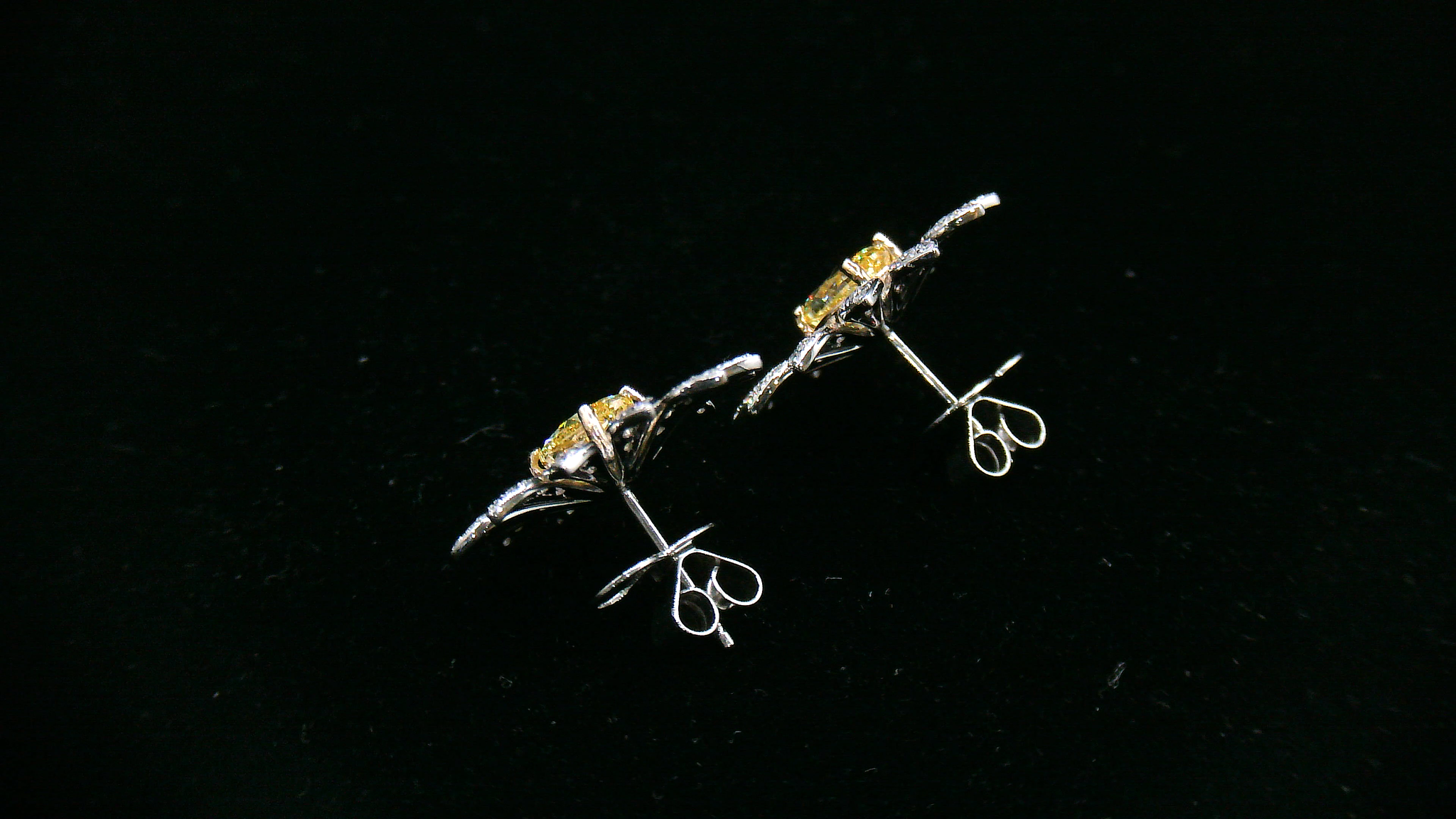 Pair of daisy-shaped diamond earrings with yellow diamond center stone 