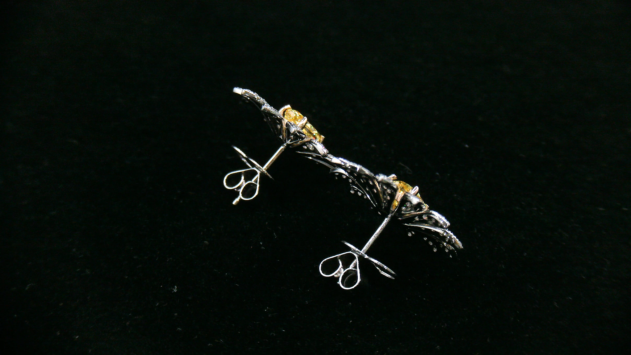 Pair of daisy-shaped diamond earrings with yellow diamond center stone 